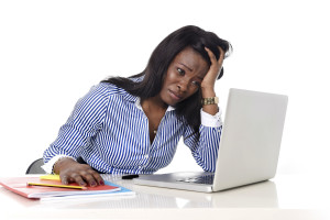 black African American ethnicity tired and frustrated woman working as secretary in stress at work office desk with computer laptop desperate in business frustration concept